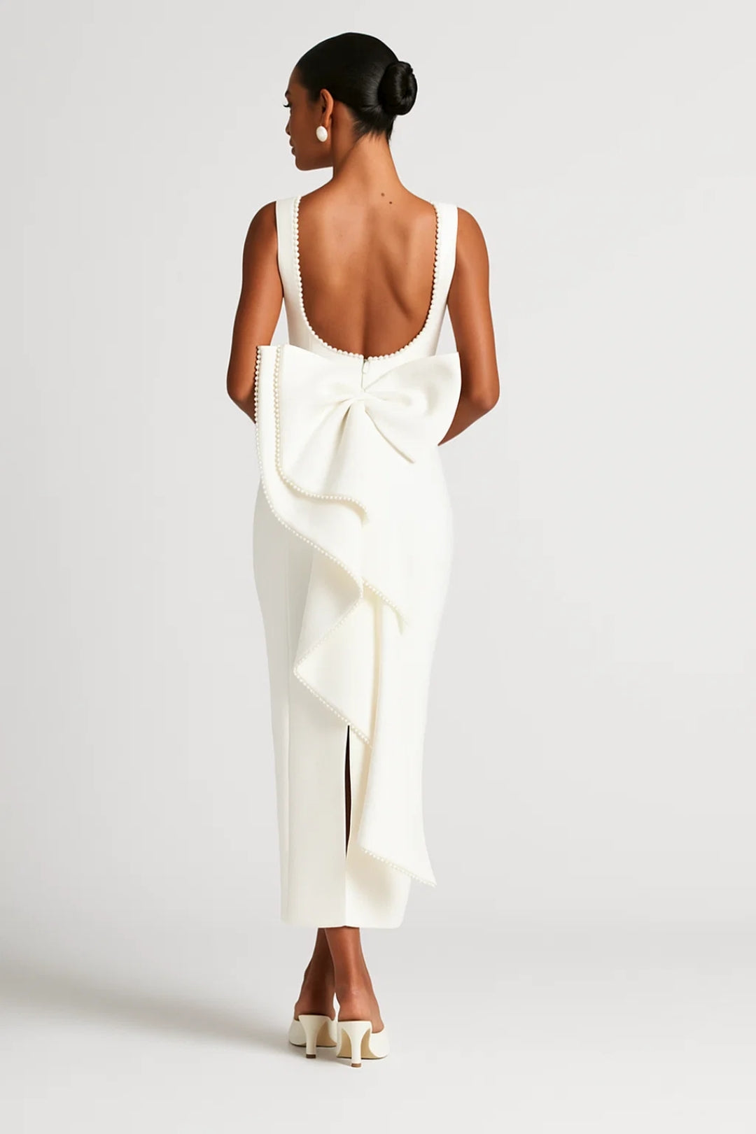 Elegant long dress with decorated neckline and back bow | Sophisticated ceremony style